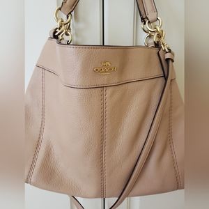 Coach leather satchel handbag, Nude color, with handles and shoulder strap.